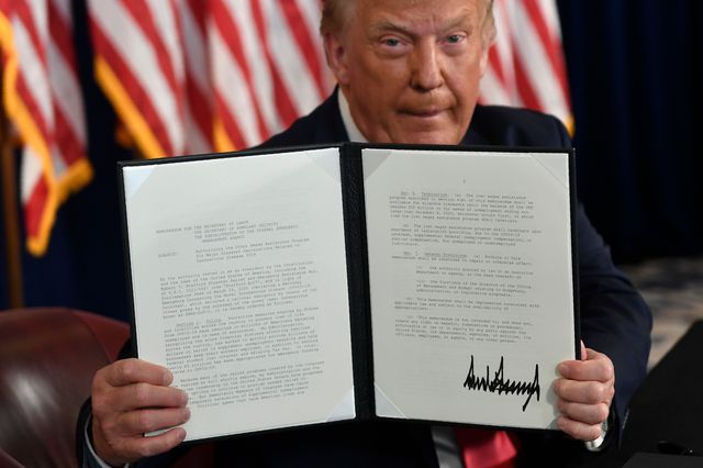 President Donald Trump hold up one of the four executive orders that he signed that addresses the economic fallout from the COVID-19 pandemic at his Trump National Golf Club in Bedminster, New Jersey on August 8th, 2020.